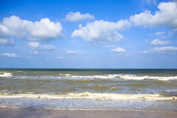 Fototapeta na wymiar moving wave to a beach clear sky