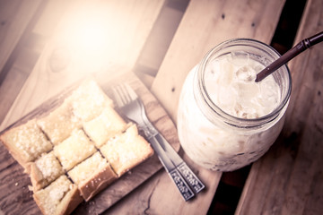 top view of milk with sweet toast on wooden table 