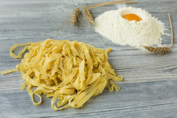 Home made pasta on wooden ground