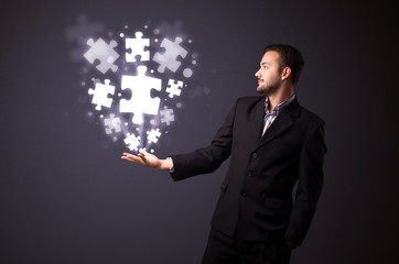 Puzzle pieces in the hand of a businessman