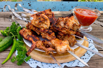 Skewers of meat rabbit on a wooden table