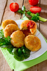 Vegetable burgers made from potatoes, corn and green peas on a wooden table