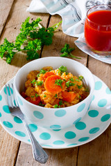 Braised cabbage with rice on a wooden table