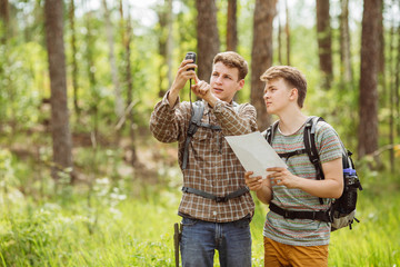 two tourist determine the route map and navigator