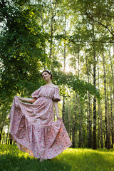 Fototapeta premium Young beautiful woman in the garden