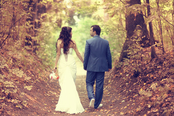 autumn wedding in the park bride and groom in a white dress
