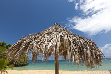 straw umbrella on a tropical beach