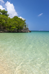 Beach on tropical island. Clear blue water and sky 