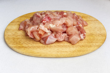chicken pieces on a cutting board white background