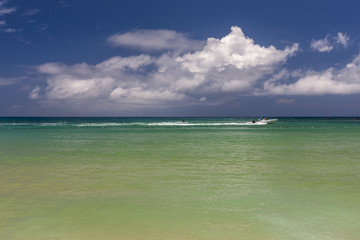 Beach on tropical island. Clear blue water and sky 