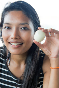 young happy woman showing a peeled egg