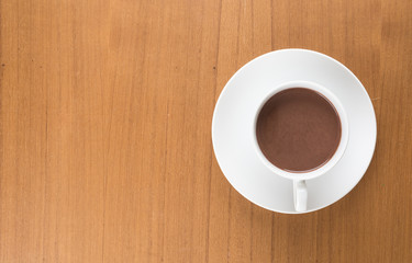 a cup of chocolate on wood table