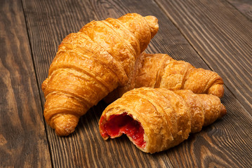 Croissants lying on an old wooden table