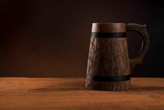 Mug of fresh beer on a wooden table.