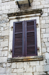 Fototapeta na wymiar Window with louvers in old house