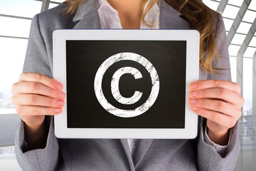 Composite image of businesswoman showing tablet