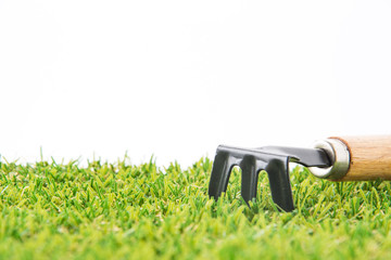 green grass turf on white with fork