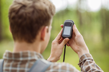tourist  in the woods determines location using gps