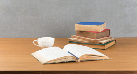 old book with pencil and coffee