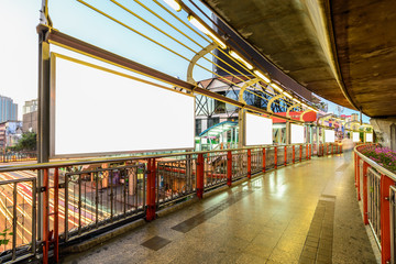 Obraz premium Blank advertising panel at sidewalk in city.