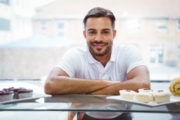  Smiling worker posing behind the counter