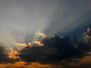 Obraz na płótnie Canvas Dramatic sun rays through the clouds - crepuscular rays 