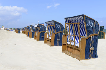 Fototapeta na wymiar Empty sunbathing chairs on the beach.