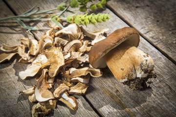 Boletus Edilus mushrooms on a wooden table  – fresh and dried