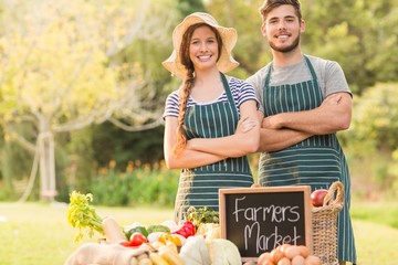 Happy farmers standing arms crossed
