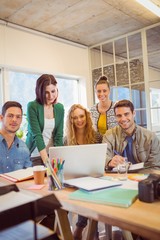 Portrait of smiling casual colleagues using computer