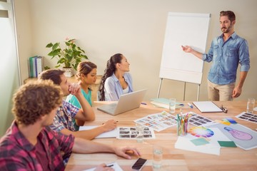 Casual businessman giving presentation to his colleagues