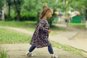 Fototapeta premium little girl for a walk in the park