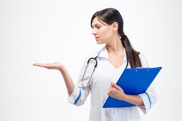 Doctor with clipboard holding copyspace on her palm