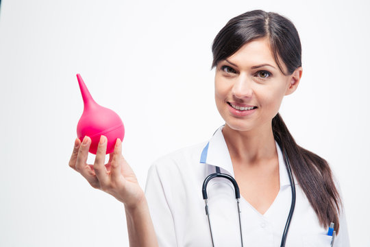 Happy female doctor holding enema