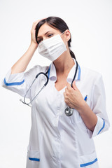 Medical doctor in mask having headache
