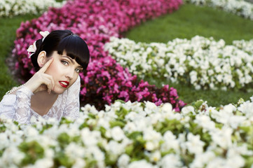 Fototapeta premium Beautiful brunette laying on the grass