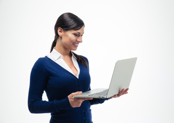 Businesswoman standing and using laptop