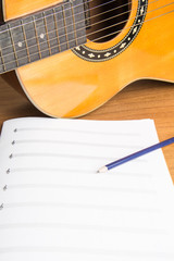 guitar notebook and pencil