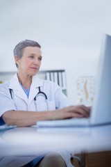 Female doctor using her laptop computer 