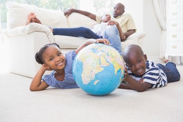 Happy siblings using their globe 