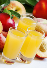 Fresh peach juice with fruits on a white wooden background, sele