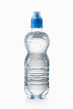 Water. Small plastic water bottle with water drops on white back