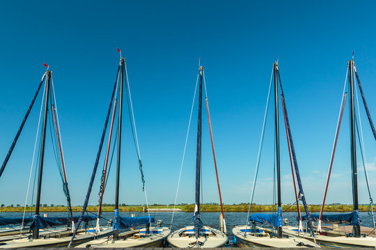 Row of small Dutch sailing boats used for lessons