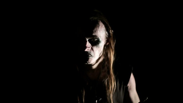 Drummer of black metal band. Close up dark background. Slow motion