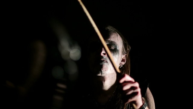 Drummer of black metal band. Close up dark background