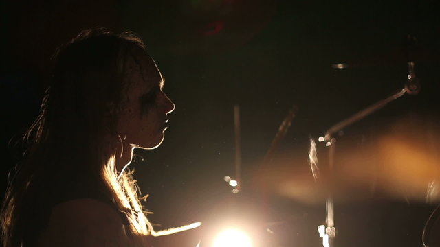 Drummer of black metal band. Close up profile face