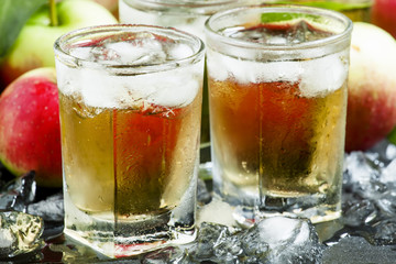 Cool refreshing apple juice with ice and fruit, selective focus