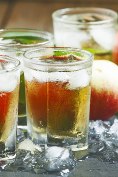 Cool refreshing apple juice with ice and fruit, selective focus