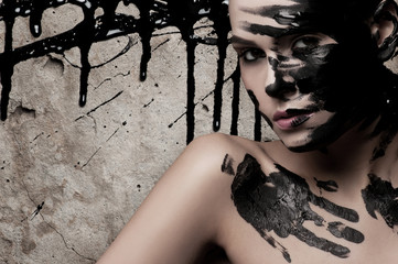 Creative portrait of a girl with paint on his face.