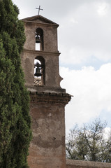 Fototapeta na wymiar bell tower next to a cypress tree